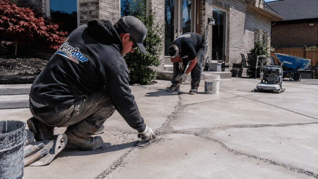 Professional concrete patio repair contractors repairing cracked concrete patio in Kitchener Ontario